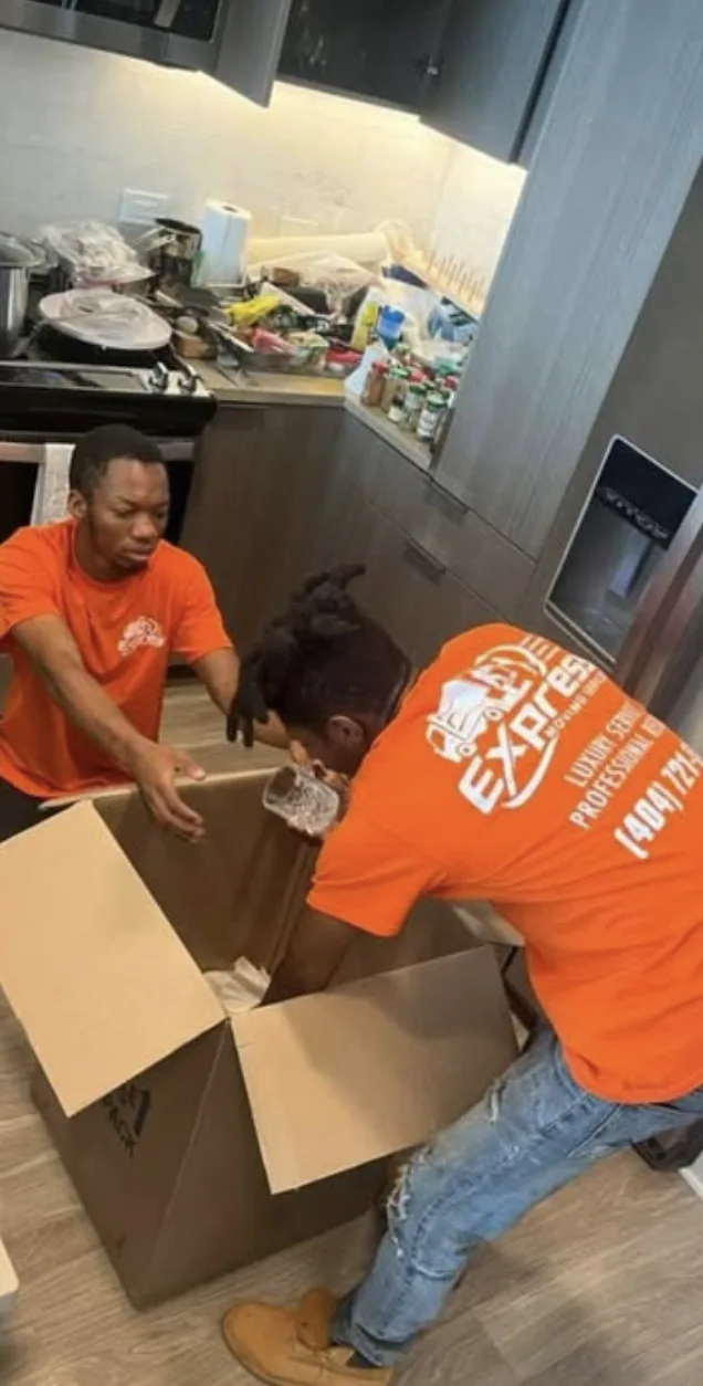 Express Moving Services crew packing kitchen items into a box