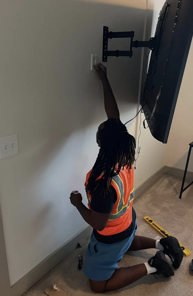 Wall-mounted television position being checked in a home